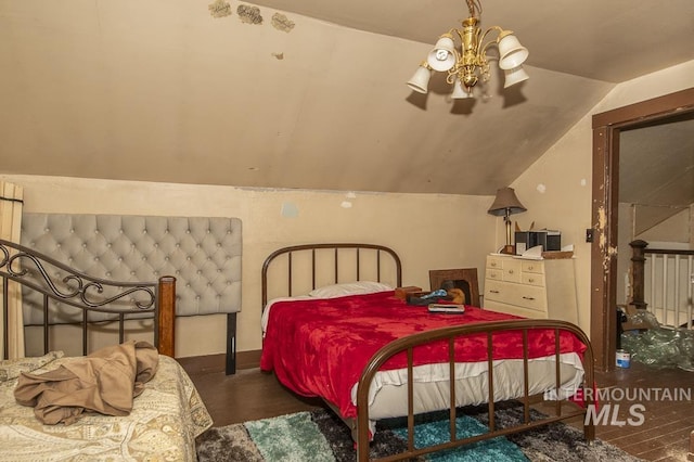 bedroom with an inviting chandelier and lofted ceiling