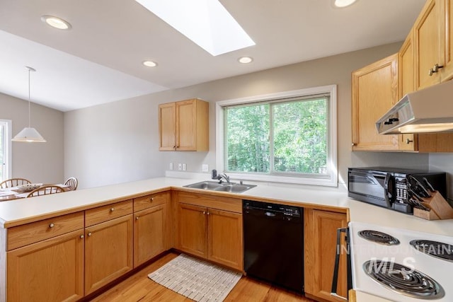 943 Colt Rd, Moscow, ID 83843 - kitchen featuring black appliances, a sink, a peninsula, a skylight, and under cabinet range hood