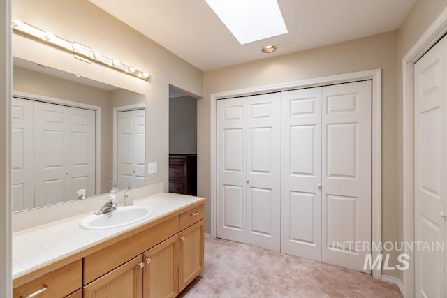 943 Colt Rd, Moscow, ID 83843 - bathroom featuring a closet, a skylight, vanity, and recessed lighting