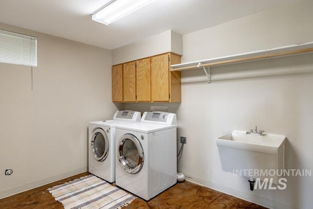 943 Colt Rd, Moscow, ID 83843 - washroom featuring independent washer and dryer, cabinet space, and baseboards
