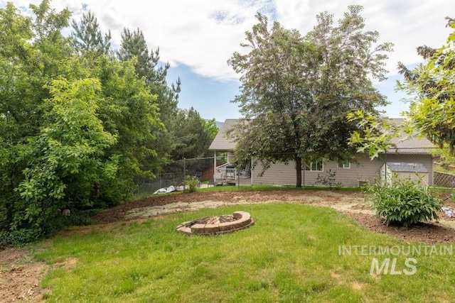 943 Colt Rd, Moscow, ID 83843 - view of grassy yard with an outdoor fire pit and a wooden deck