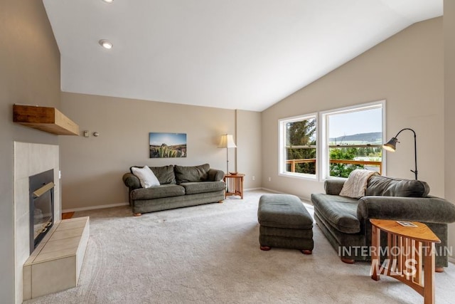 943 Colt Rd, Moscow, ID 83843 - carpeted living area featuring vaulted ceiling, a tile fireplace, and baseboards