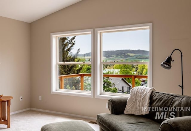 943 Colt Rd, Moscow, ID 83843 - sitting room with light colored carpet, plenty of natural light, baseboards, and lofted ceiling