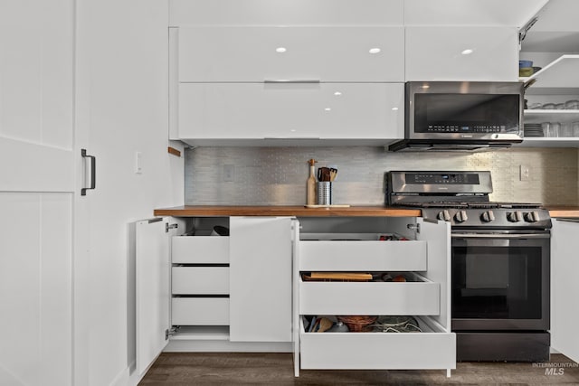 kitchen featuring white cabinetry, modern cabinets, tasteful backsplash, and stainless steel appliances