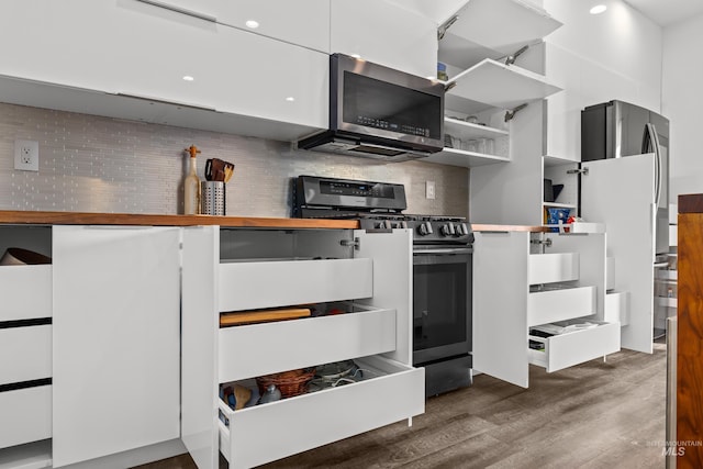 kitchen featuring decorative backsplash, open shelves, dark wood-style floors, and stainless steel appliances