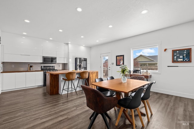 dining space featuring recessed lighting, baseboards, and dark wood-style floors