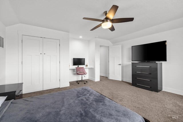 unfurnished bedroom featuring baseboards, carpet floors, lofted ceiling, and a ceiling fan
