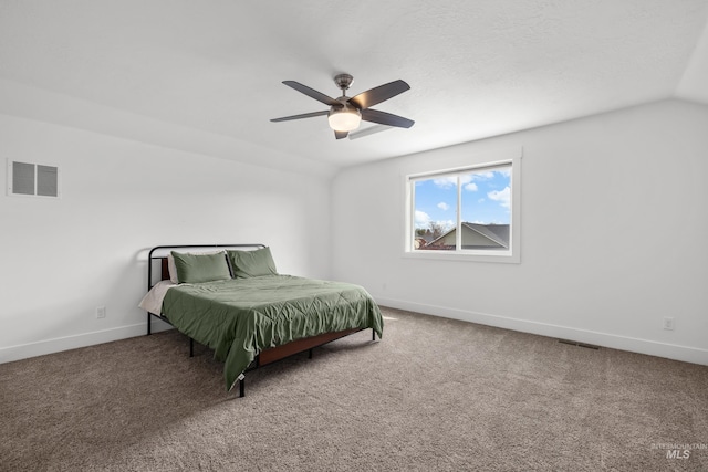 carpeted bedroom featuring a ceiling fan, lofted ceiling, baseboards, and visible vents