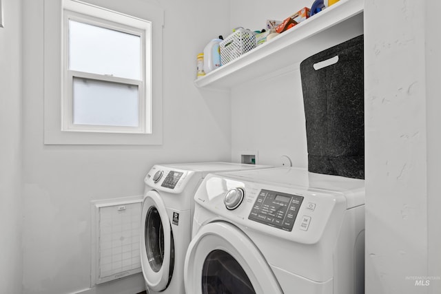 laundry room featuring washing machine and dryer and laundry area
