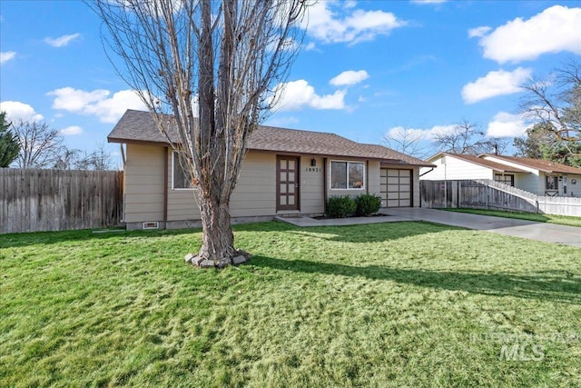 ranch-style home featuring a front lawn, fence, a garage, and driveway