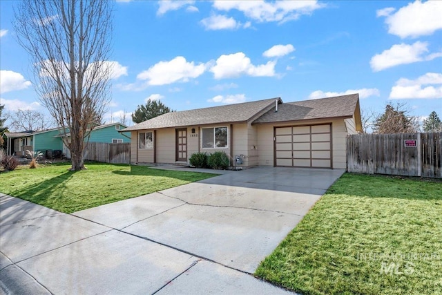 ranch-style house with a shingled roof, a front lawn, fence, a garage, and driveway