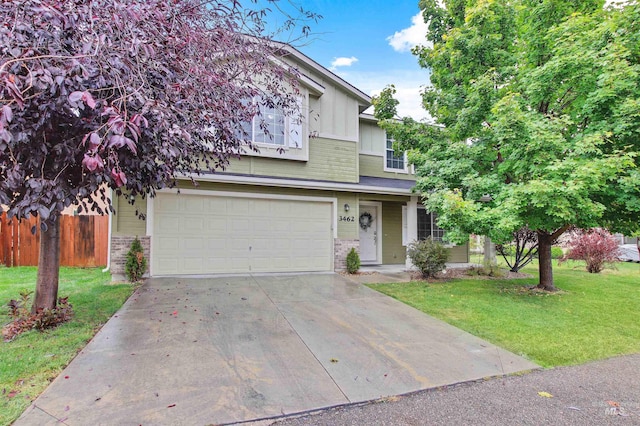 view of front of property with a front yard and a garage