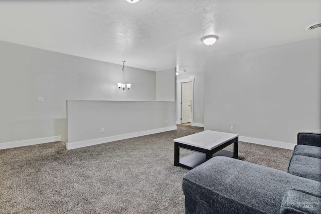 living room featuring dark carpet and a chandelier