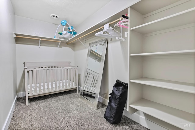 walk in closet featuring carpet floors