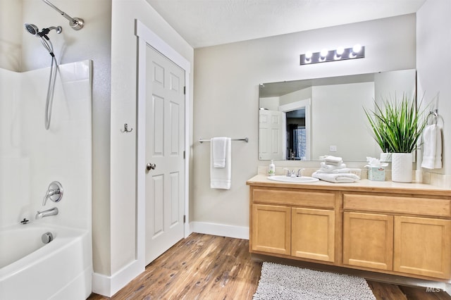 bathroom with shower / tub combination, vanity, a textured ceiling, and hardwood / wood-style floors