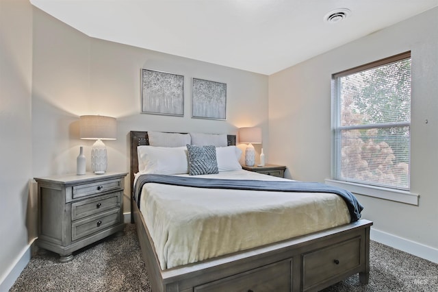 bedroom with dark colored carpet