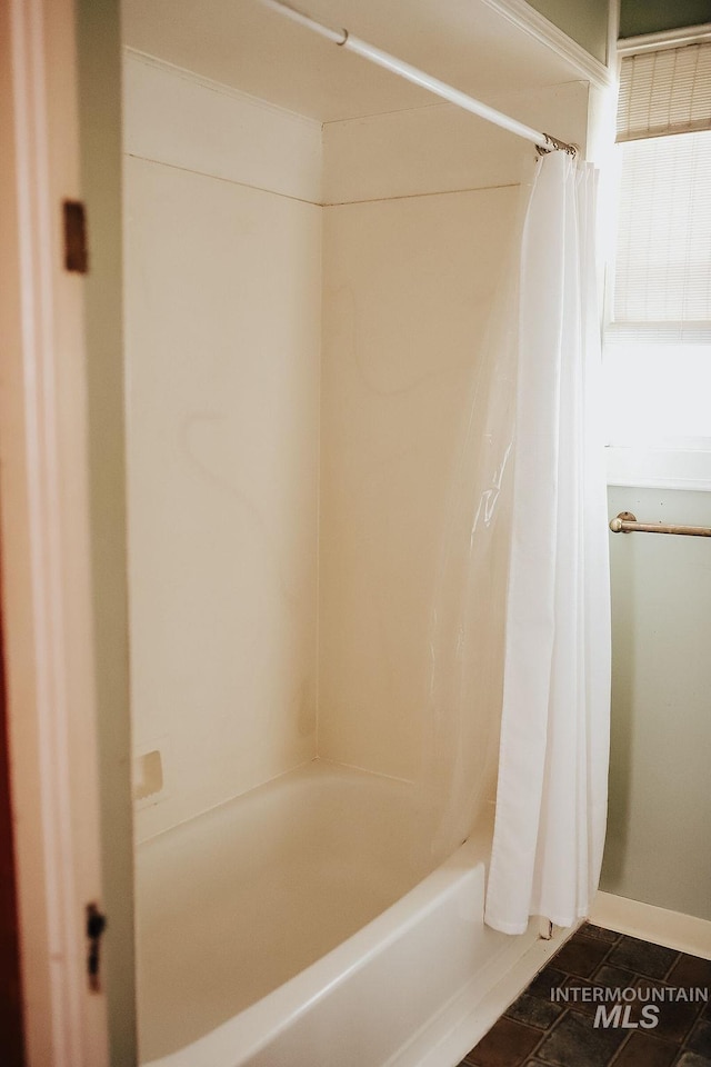 bathroom with shower / bathtub combination with curtain and tile patterned flooring