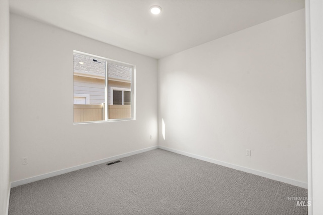 unfurnished room featuring visible vents, baseboards, and carpet flooring