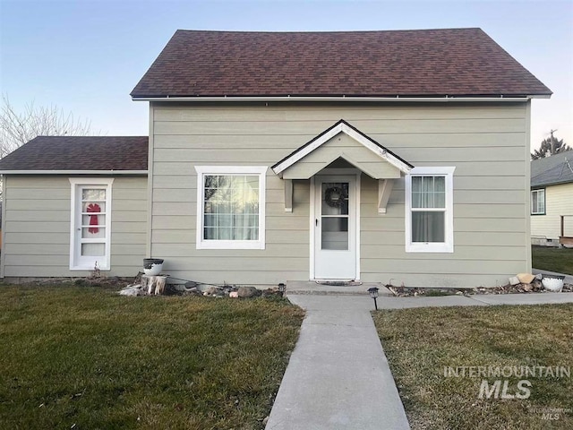 bungalow-style home featuring a front yard