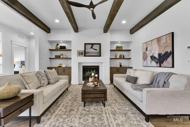 2493 E Galleon Ln, Meridian, ID 83642 - living area with ceiling fan, wood finished floors, beamed ceiling, a glass covered fireplace, and recessed lighting