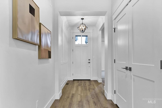2493 E Galleon Ln, Meridian, ID 83642 - doorway to outside featuring hardwood / wood-style floors, a chandelier, and baseboards