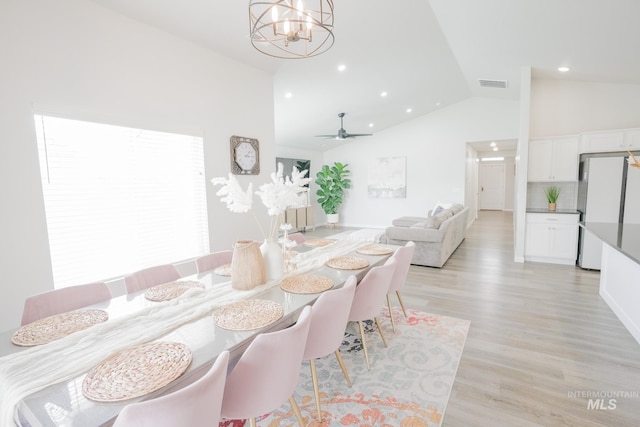 6073 W Mikonos St, Meridian, ID 83646 - dining space with vaulted ceiling, recessed lighting, a chandelier, light wood-style flooring, and a ceiling fan