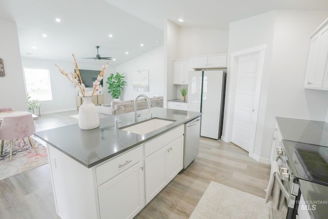 6073 W Mikonos St, Meridian, ID 83646 - kitchen with a sink, white appliances, a ceiling fan, light wood-style floors, and vaulted ceiling