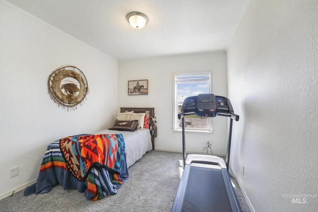 carpeted bedroom with a textured wall and baseboards