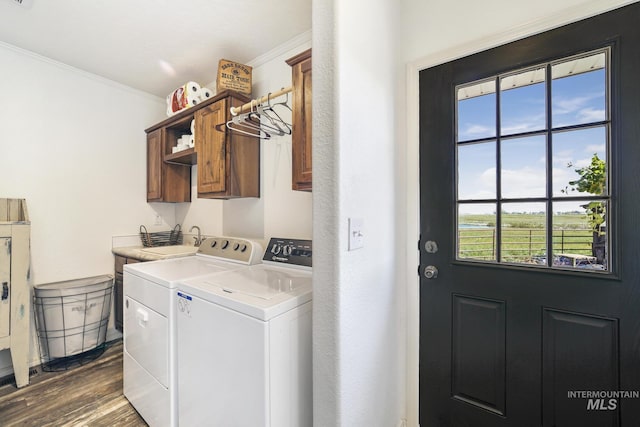 clothes washing area featuring independent washer and dryer, dark wood finished floors, cabinet space, and crown molding