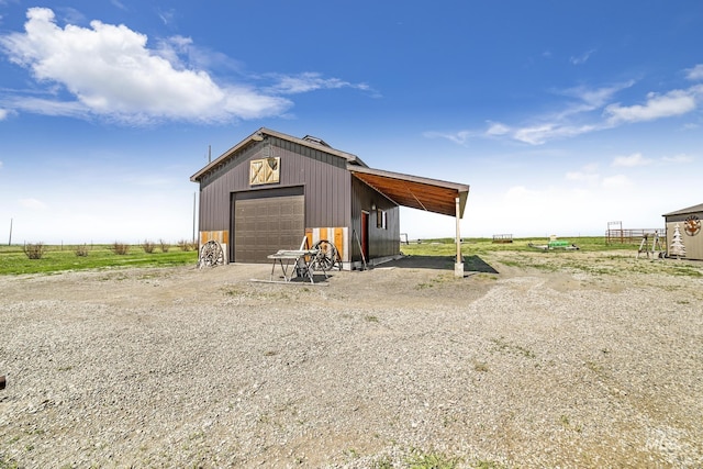 view of pole building featuring driveway and a rural view