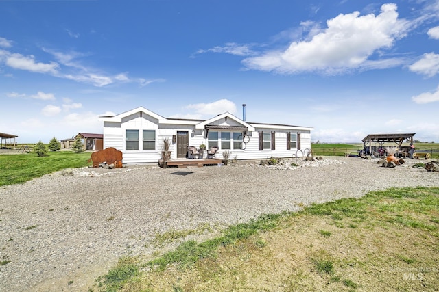 view of front of home with a lawn and a deck