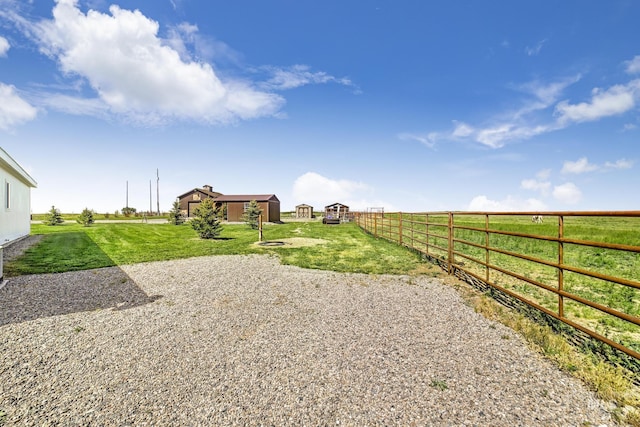 view of yard featuring a rural view and fence