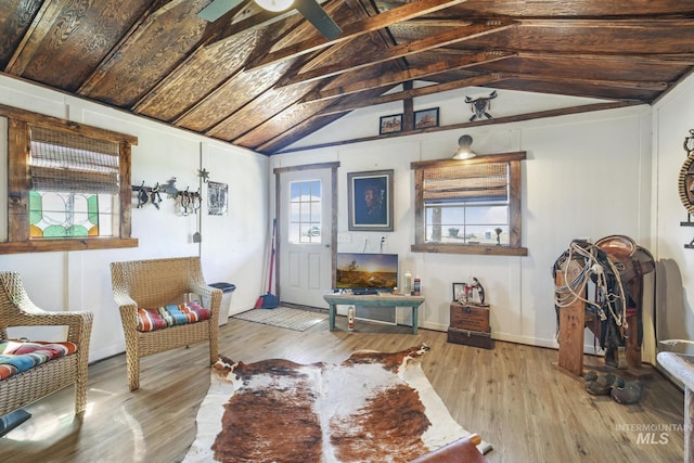 living area featuring vaulted ceiling and light wood finished floors