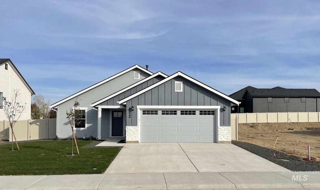 view of front of house with a garage and a front yard