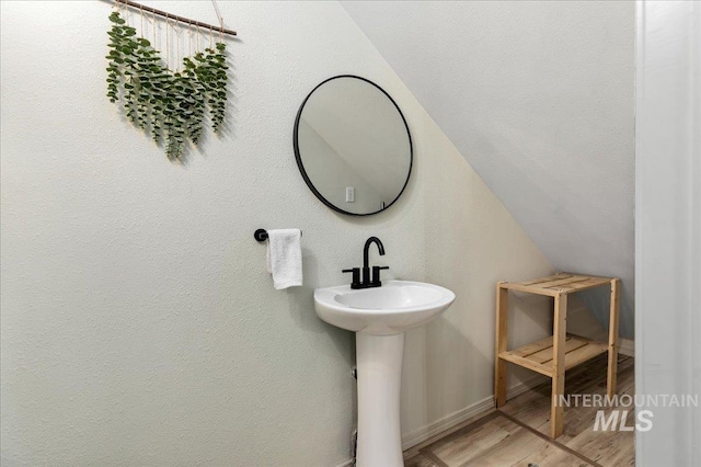 bathroom featuring baseboards and wood finished floors