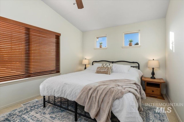 carpeted bedroom featuring visible vents, baseboards, ceiling fan, and lofted ceiling