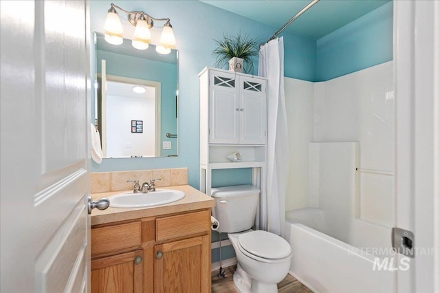full bathroom with vanity, shower / bathtub combination with curtain, and toilet