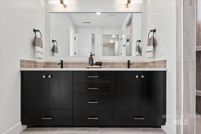 bathroom with decorative backsplash and vanity