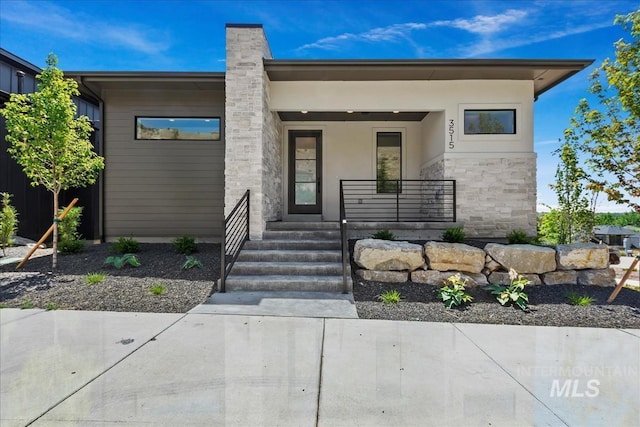 contemporary house featuring covered porch