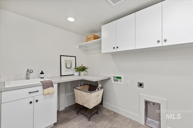 clothes washing area featuring sink, washer hookup, cabinets, hookup for an electric dryer, and light tile patterned floors