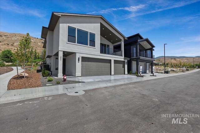 contemporary home featuring a mountain view and a garage