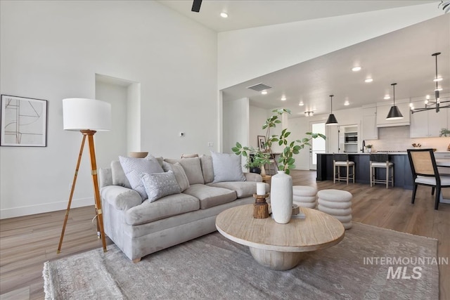 living room featuring lofted ceiling and wood-type flooring