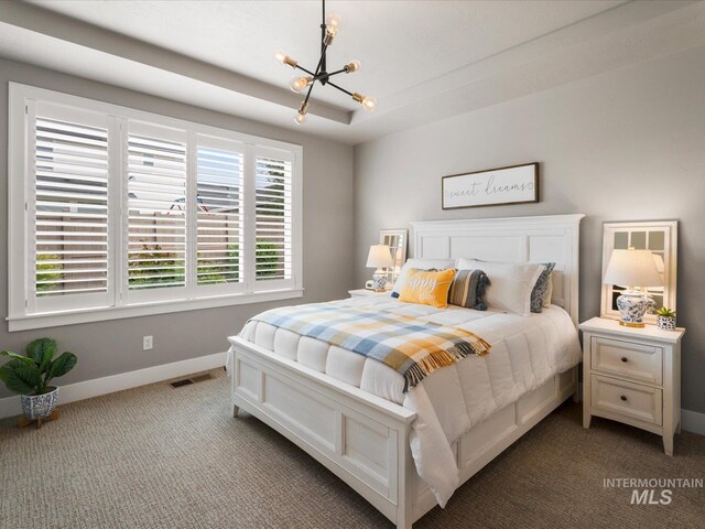 bedroom with a chandelier, baseboards, and carpet floors
