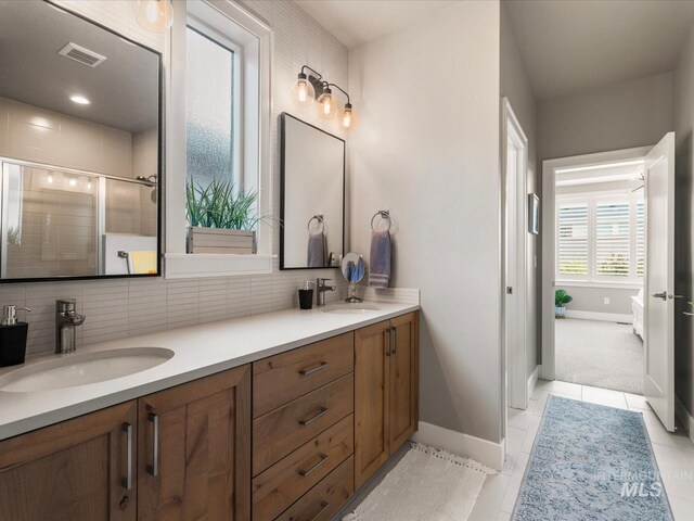 full bathroom featuring tasteful backsplash, baseboards, and a shower stall