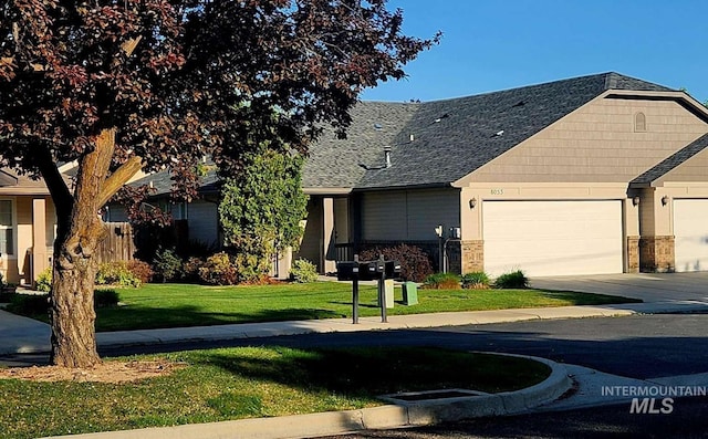 8053 N Duncan Ln, Boise, ID 83714 - view of front of home with a front lawn, an attached garage, roof with shingles, and driveway