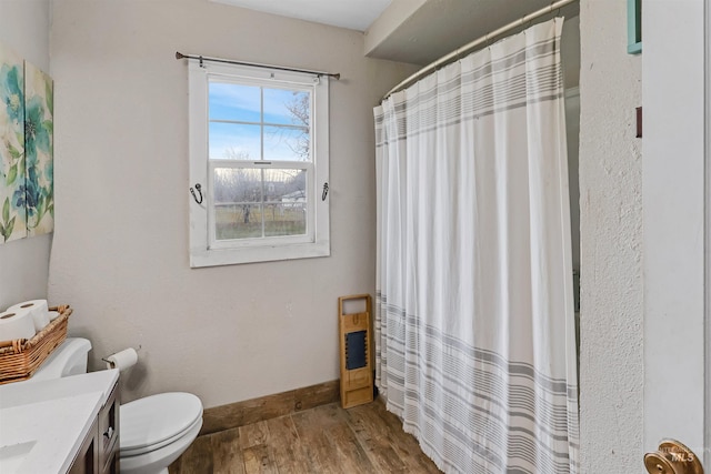 bathroom featuring a shower with curtain, vanity, wood-type flooring, and toilet