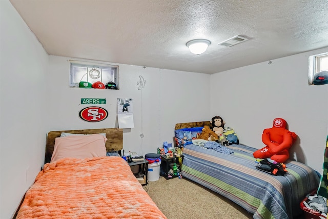 carpeted bedroom featuring a textured ceiling