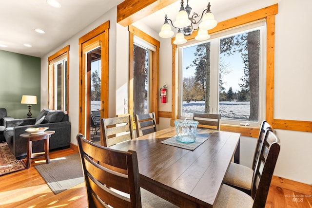 dining space with light wood-style floors, recessed lighting, and a chandelier