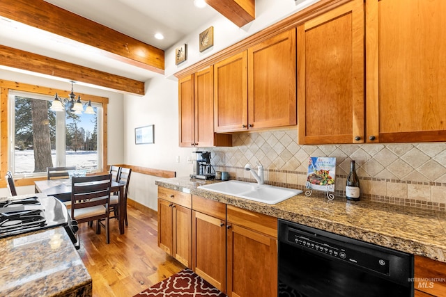 kitchen featuring light wood-type flooring, black appliances, a sink, and beamed ceiling