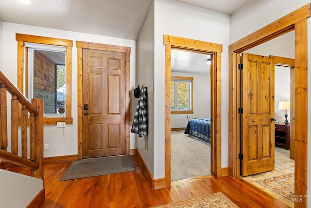 entryway featuring baseboards and wood finished floors